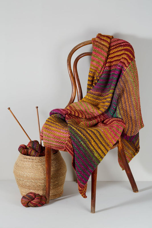 Urth Yarns Uneek Worsted Ikat Throw Kit, finished example draped over a chair
