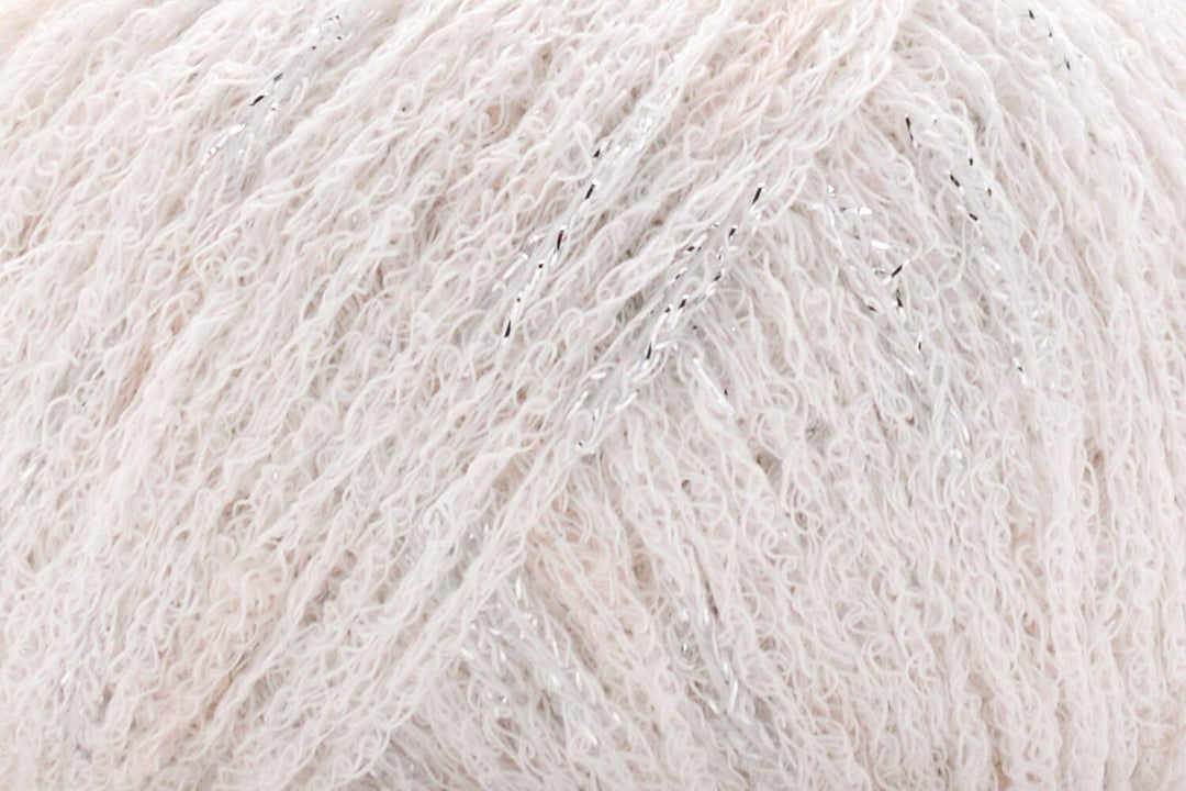 Close-up of a ball of light white yarn with metallic flecks