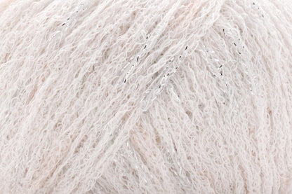 Close-up of a ball of light white yarn with metallic flecks