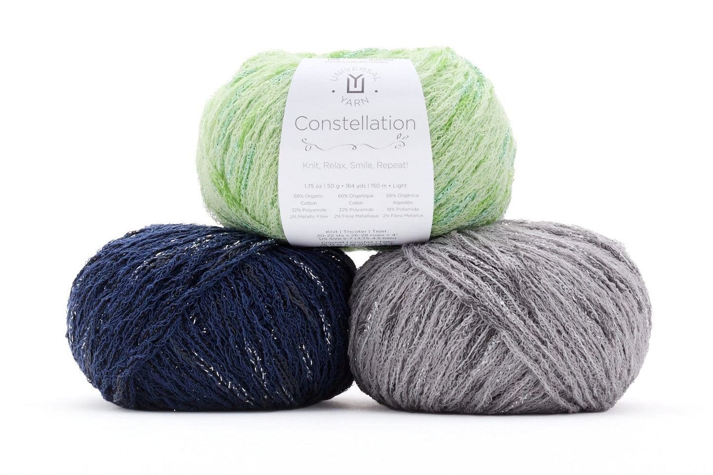 Three balls of yarn in green, blue, and gray with a label on a white background