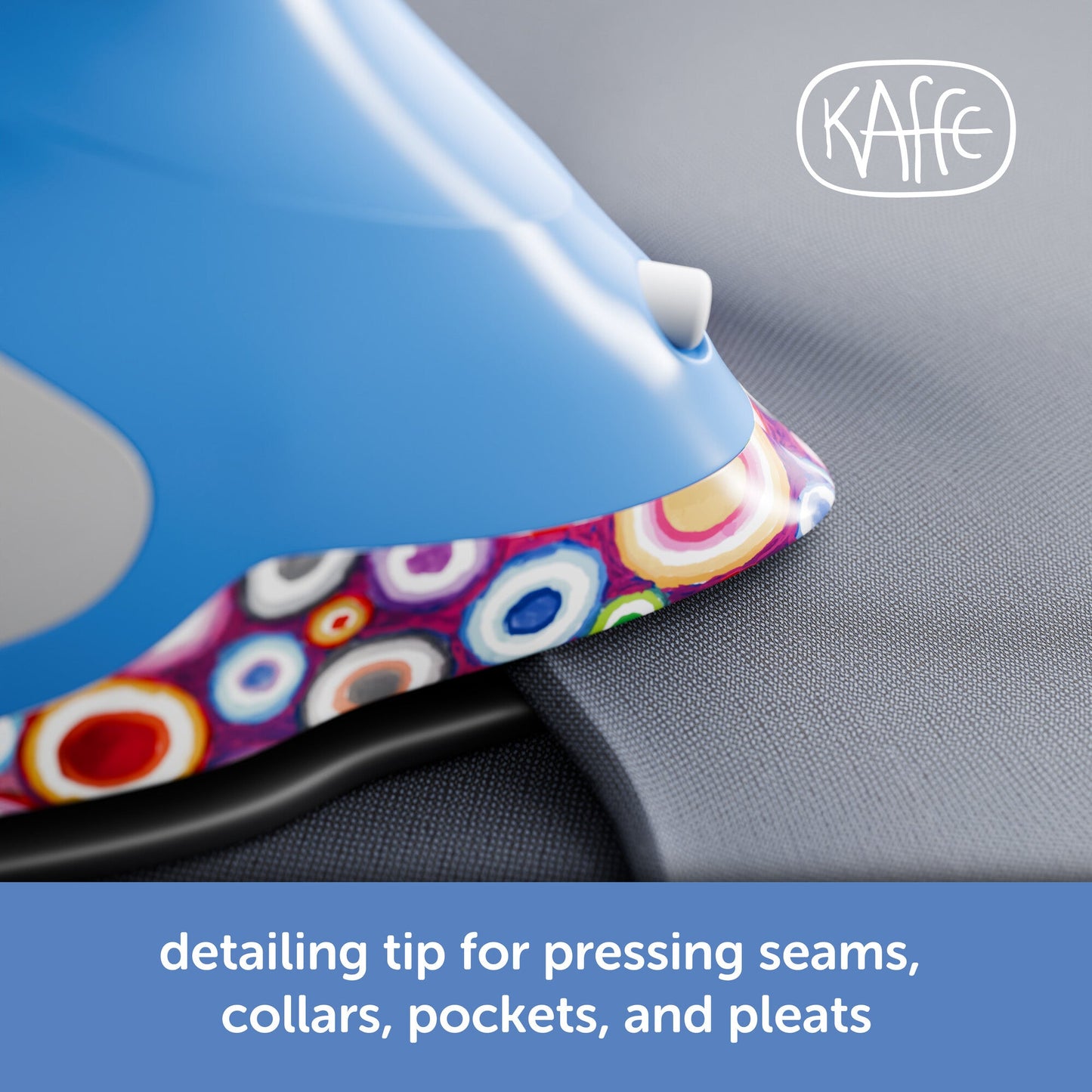 Blue iron with colorful handle pressing fabric, Kaffe brand visible