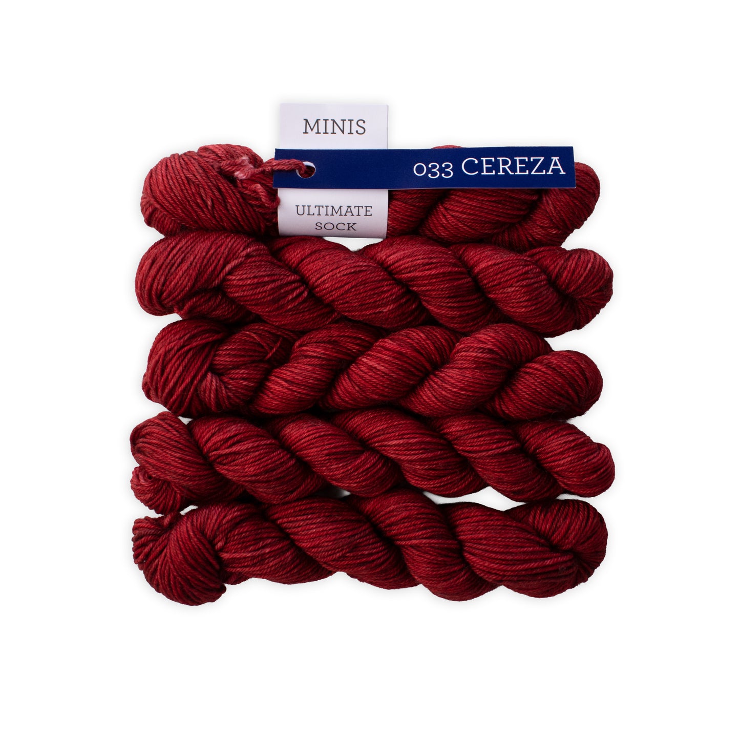 Red yarn skeins with a label on a white background