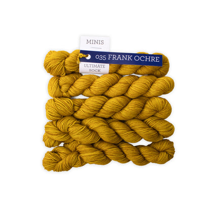 Yellow yarn skeins with a brand label on a white background