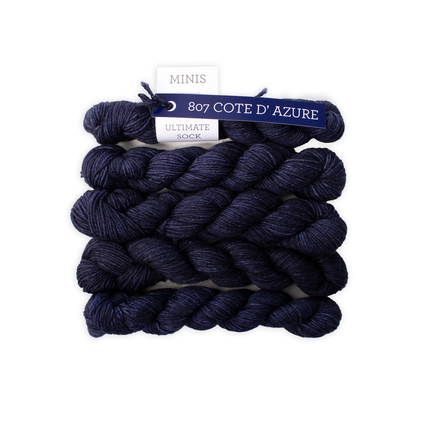 Navy blue yarn skeins with a label on a white background