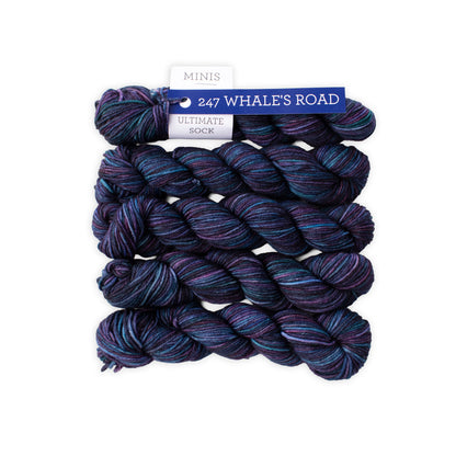 Three skeins of blue and purple yarn with a label on a white background